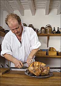 Brantley carves the bird, a favored holiday dish from the beginning, though it is not certain the Pilgrims partook on the first Thanksgiving.