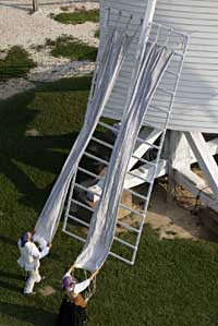 Interpreters Jonathan Hallman and Vogel unfurl the mill sails. 