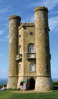 The neo-Gothic tower on a ridge in Worcestershire with turrets and parapets but also windows in the Georgian style.