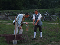 If the time of year and the time of night were propitious, buried treasure awaited diligent searchers—here, interpreters Richard Davis, left, and Nat Lasley, with a dowsing rod—a conviction shared by hundreds if not thousands of colonial treasure hunters.