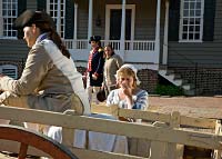 Willie Balderson as Alexander Hoy, and Donna Wolf, as wife Barbry, stand with a recruiting officer.