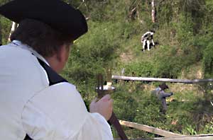 A surveyor guides two chainmen on a scramble through the brush of a hillside