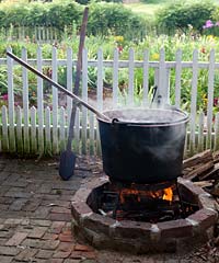 A fire fuels the iron pot ready for dyeing.